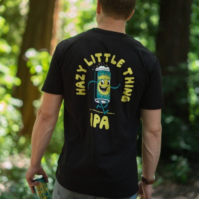 Sierra Nevada Brewing Co. Hazy Little Thing Psychedelic T-shirt back view as worn by a man standing in a wooded campground.