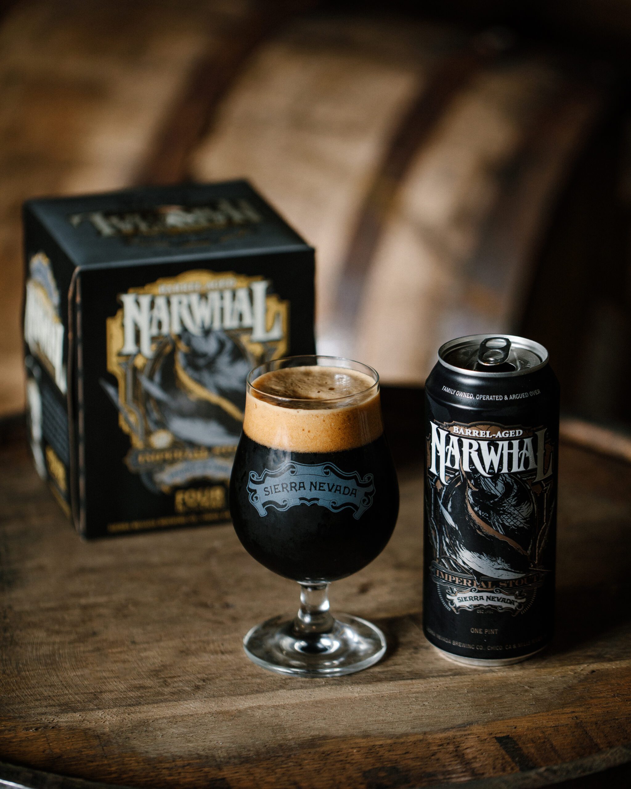 Sierra Nevada Barrel Aged Narwhal beer staged on top of a wooden barrel
