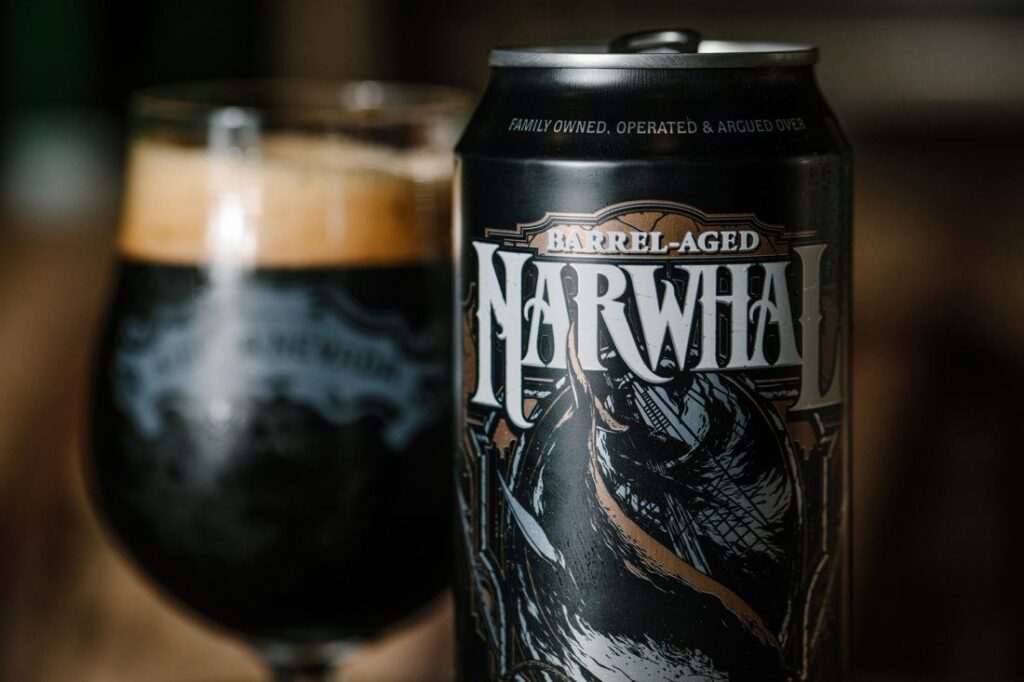 Can and poured glass of Barred-Aged Narwhal beer on a table