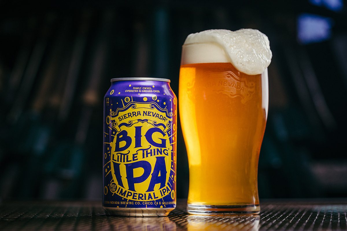 A can and full pint glass of Big Little Thing Imperial IPA