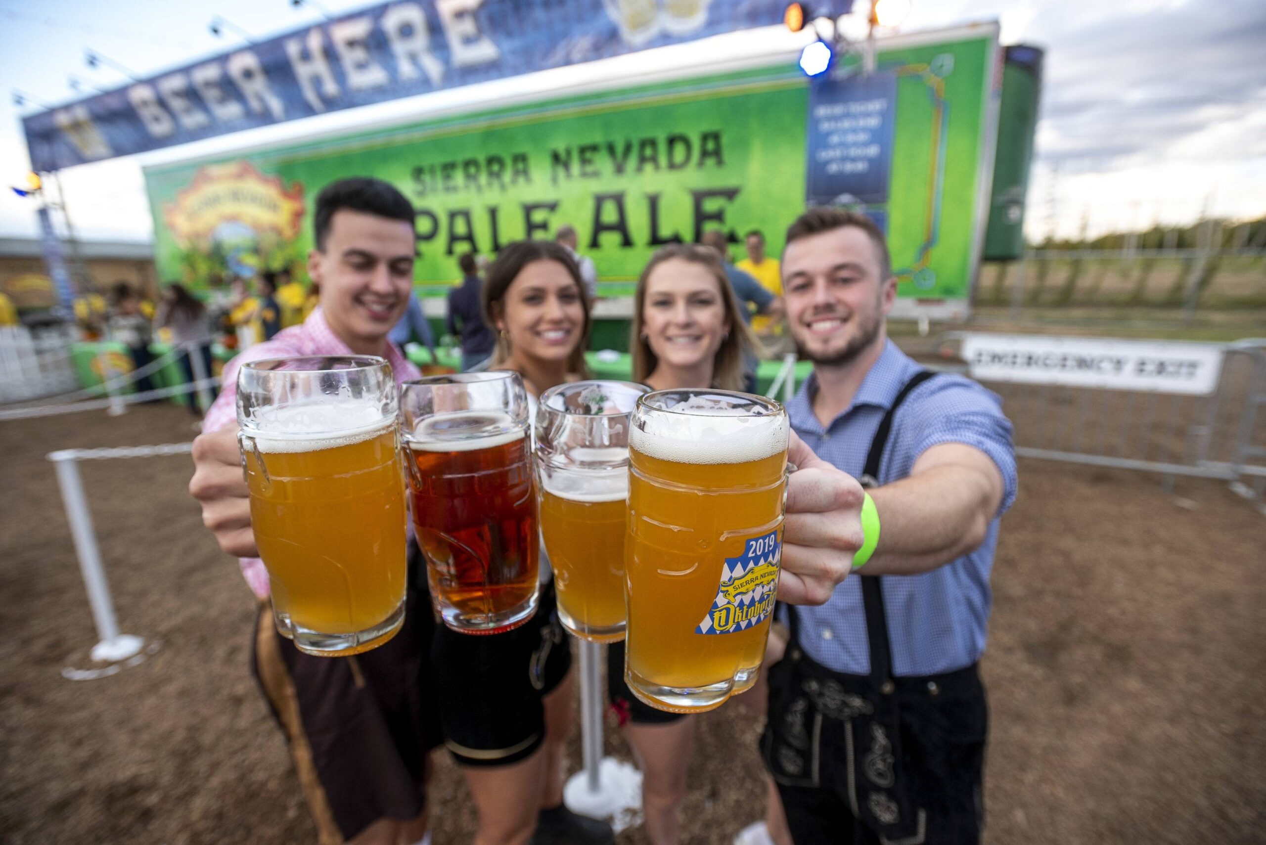Group of people raising steins of beer at Sierra Nevada Brewing Company's Oktoberfest party