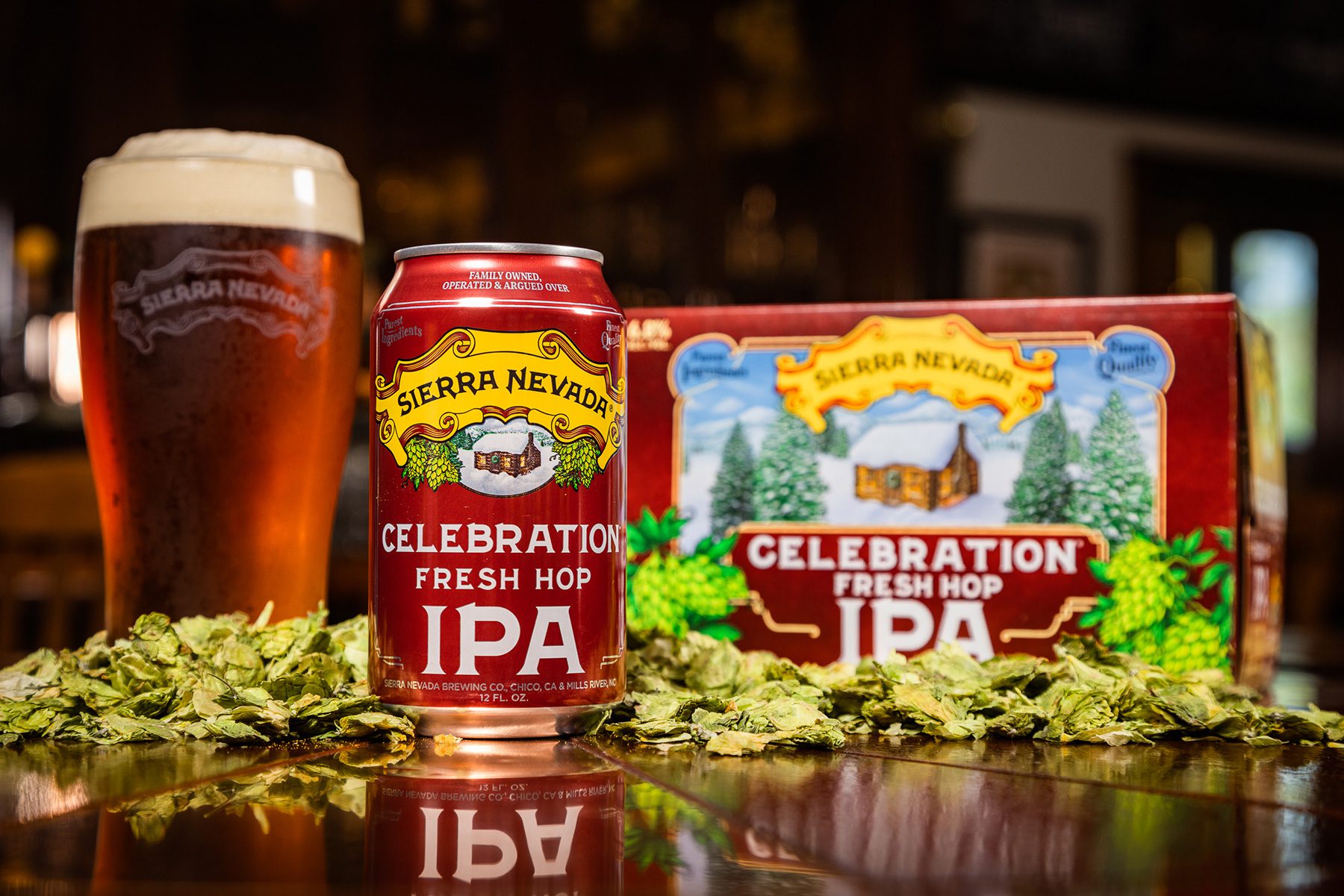 A pint glass, can, and six-pack of Sierra Nevada Celebration IPA