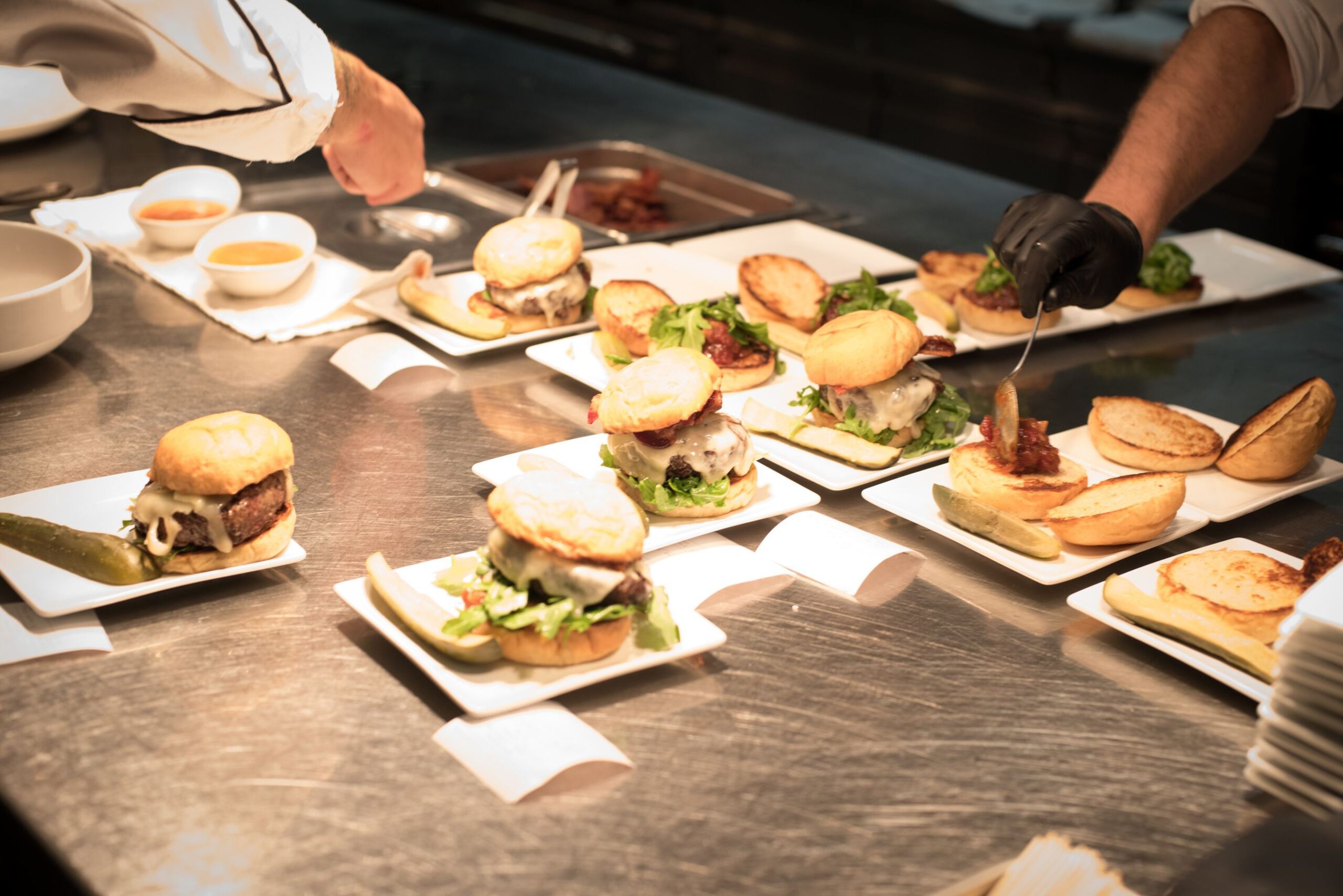 Assembly line of hamburgers in restaurant kitchen