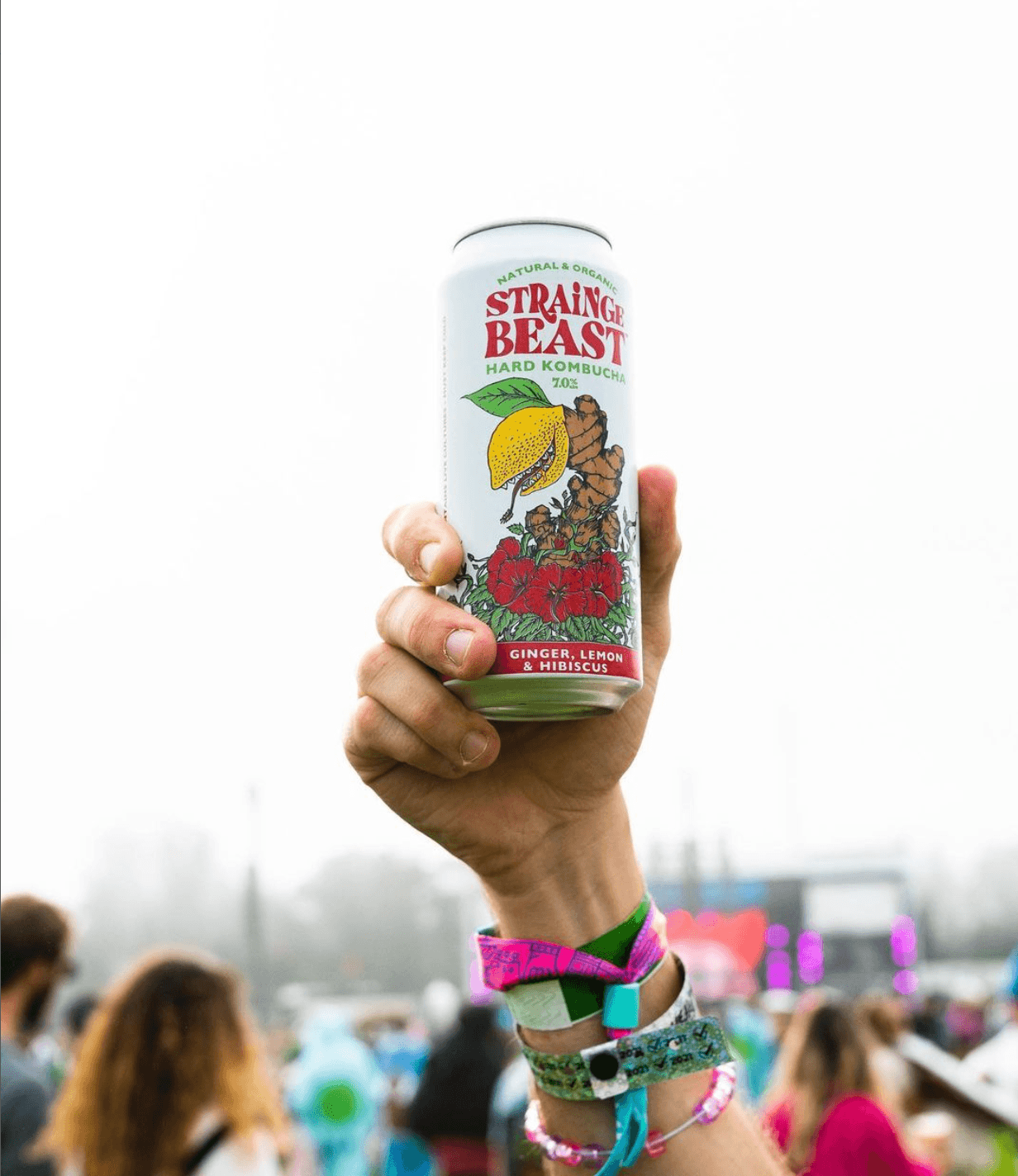 Hand holding can of Strainge Beast at a festival