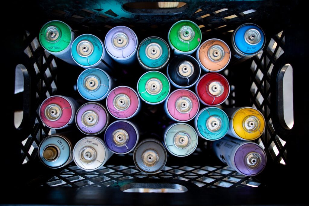 Overhead view of a box full of spray paint cans