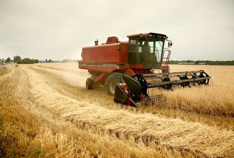 combine harvesting field of barley