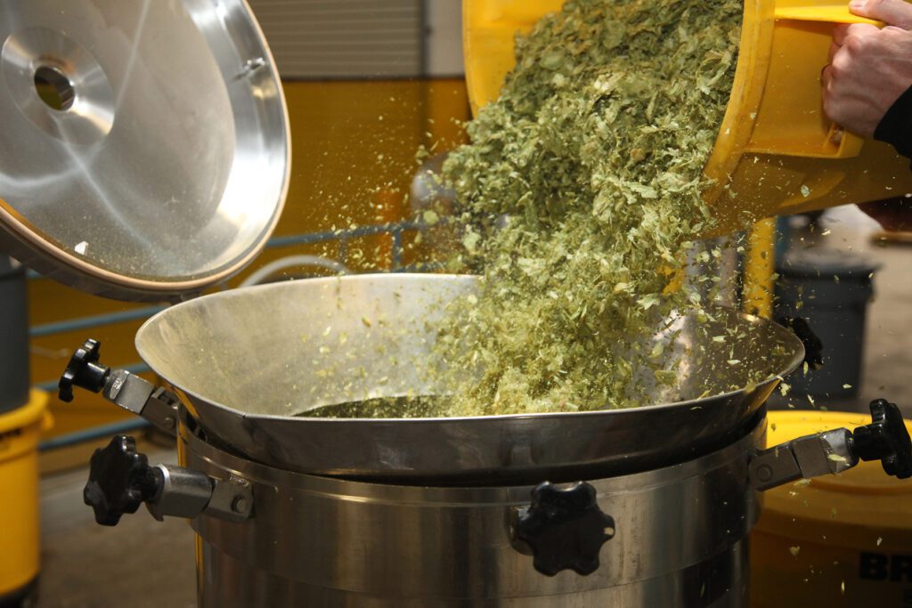Sierra Nevada brewer filling a Hop Torpedo device with hops