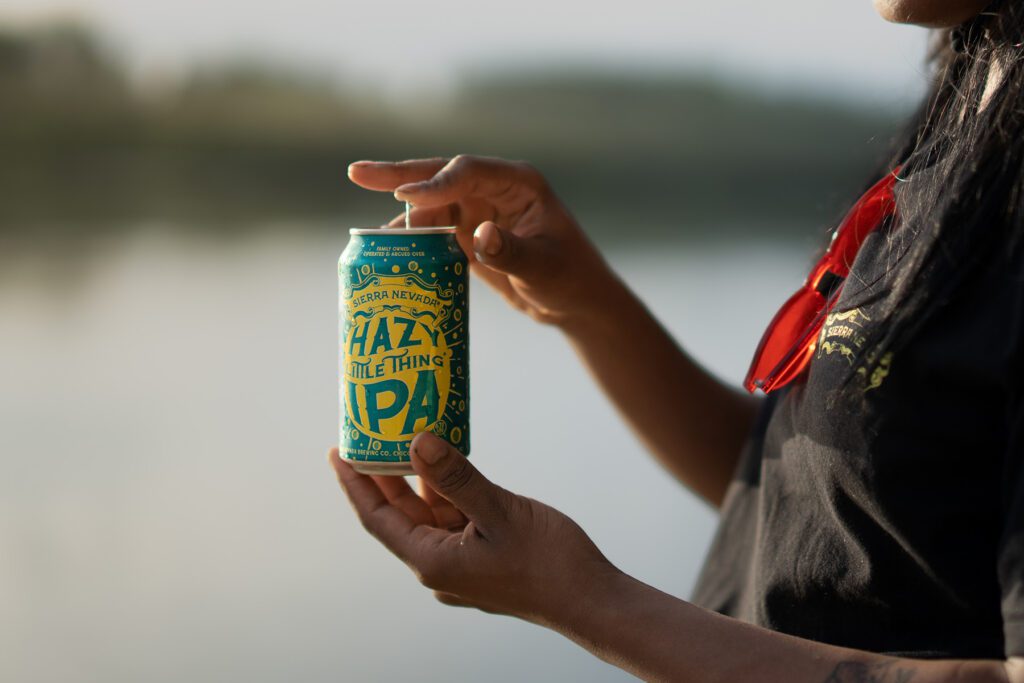 Hands opening a can of Hazy Little Thing IPA