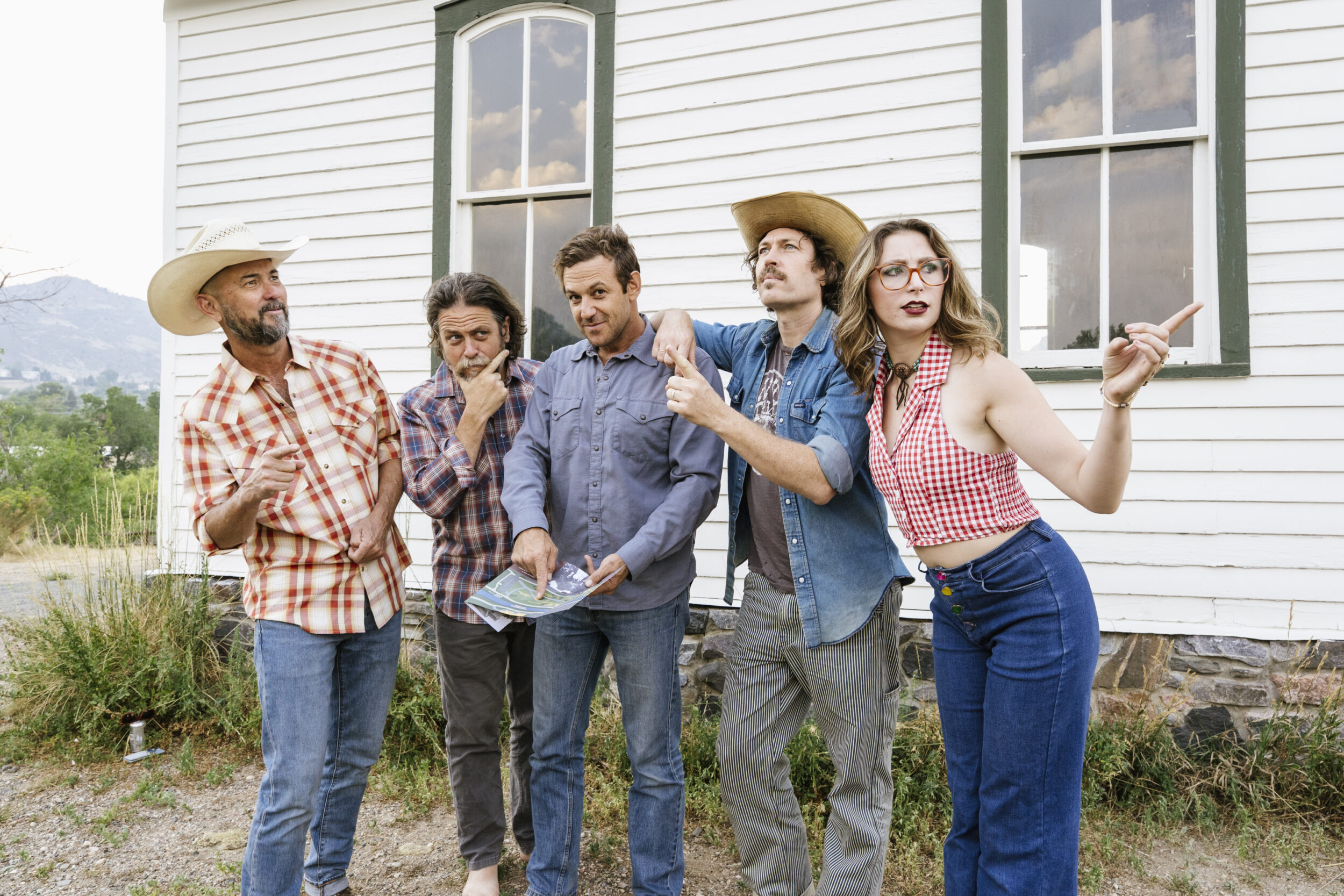Brothers Comatose band posing in from of a white house
